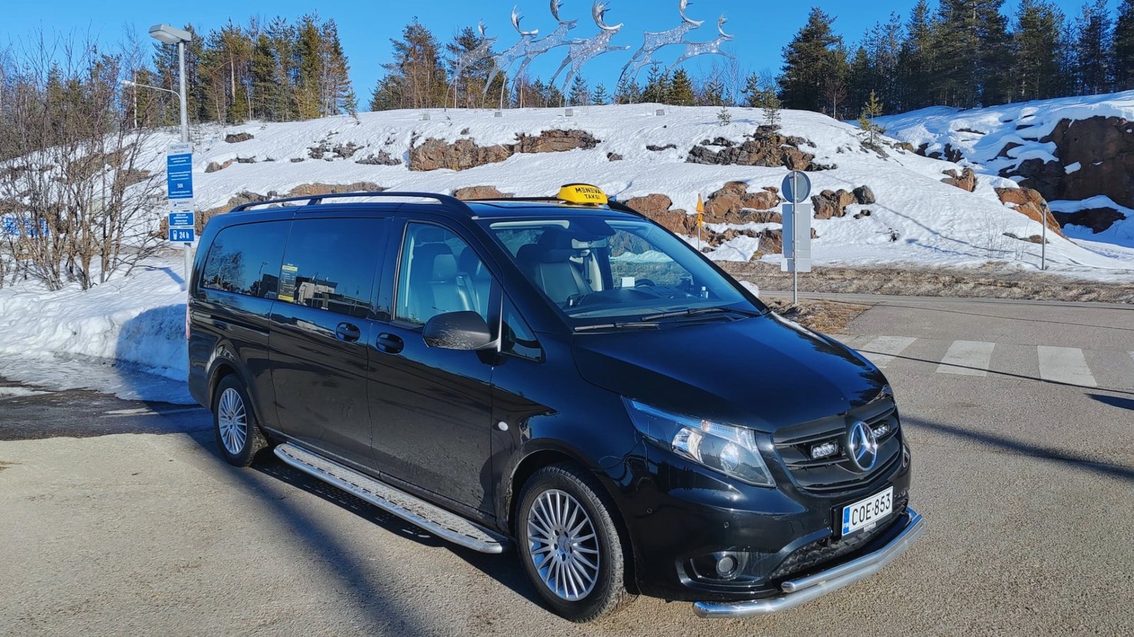 Winter airport pickup in Lapland with snowy forest background